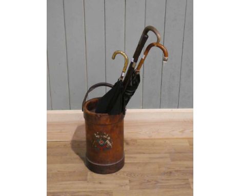 A leather cordite container with royal crest, converted as a stick stand and with two silver mounted sticks (one with horn ha