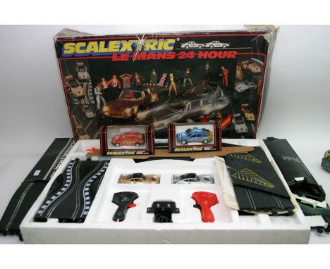A boxed scalextric Lemans racing set together with 2 boxed cars, A boxed Goodwood chicane and a boxed hump back bridge 