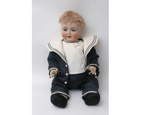 An Antique bisque head boy doll with composition body, by Simon Halibig numbered 126, in a traditional blue sailors outfit, 