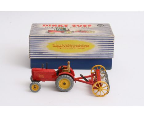 A boxed Dinky farm tractor and hay rake