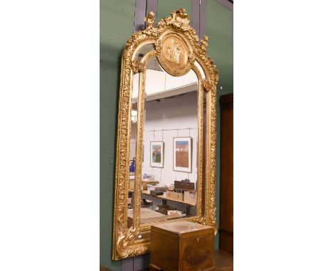 A Large Neo-Classical Style Gilt Mirror, adorned with putto shells and floral swags, 110cm by 212cm