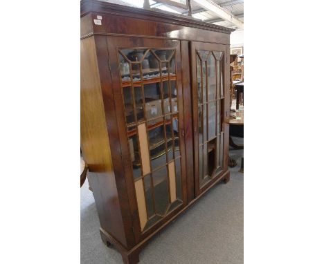 A Georgian Style Mahogany Bookcase, with twin glazed doors, 150cm by 40cm by 163cm, together with a 19th century mahogany Pem