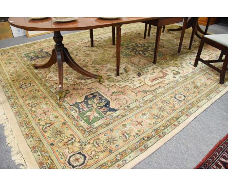 Indian Carpet of Heriz Design, the ivory field of angular vines centred by a cruciform medallion framed by stepped spandrels 