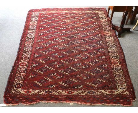 Yomut Carpet, 19th century, the pale aubergine field with columns of Dyrnak Güls enclosed by ivory borders of serrated leaves