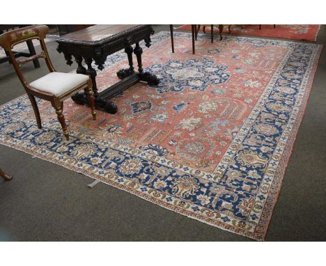 Tabriz Carpet, the terracotta field with angular vines and palmettes around an indigo medallion enclosed by indigo palmette b