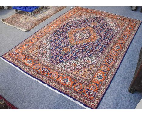 Tabriz Carpet, the indidgo Herati field with stepped anchor medallion enclosed by borders of samovar motifs and vines, 300cm 