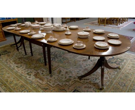 A 19th Century Mahogany Dining Table, in four sections, the pedestal d-ends on four downswept supports, brass caps and castor