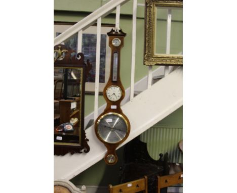 A COMITTI OF LONDON WOODEN BACKED HOME WEATHER STATION having barometer, thermometer, hydrometer, clock, etc. 