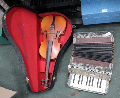 A CASE CONTAINING A VIOLIN together with a small accordion