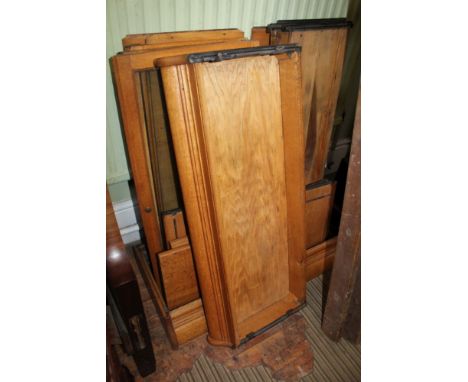 A LIGHT OAK THREE-TIER BOOK CASE with three lift-up glazed door fronts, in the Globe Wernicke style, (currently dismantled fo