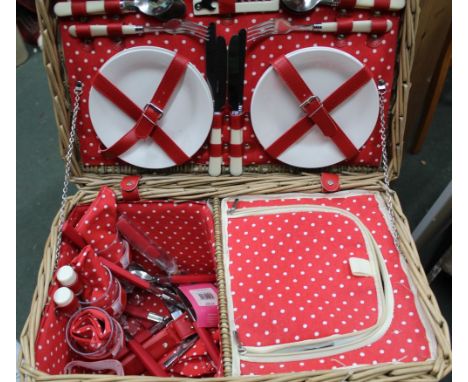 A WOVEN WICKER FITTED PICNIC HAMPER with polka dot design
