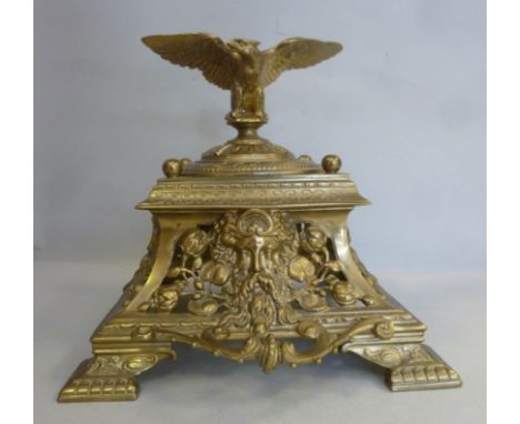 An early 20thC brass, twin handled inkstand of tapered, square design, masks of bearded men, Art Nouveau inspired floral desi
