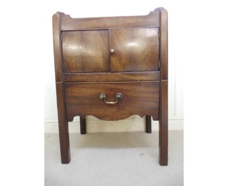 A George III mahogany night commode, having a pierced, galleried top, a pair of doors and additional drawer, over a serpentin