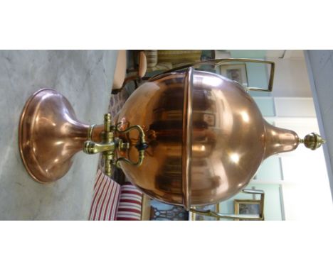 A late Victorian Griffiths & Browett copper and brass samovar of ovoid form with opposing, high, angular loop handles, a dome