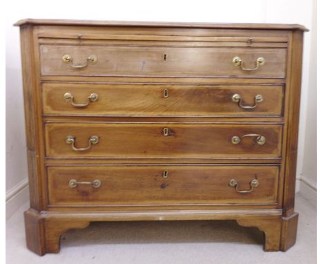 An early 19thC string inlaid mahogany dressing chest, having a brushing slide, over four long graduated drawers, flanked by f