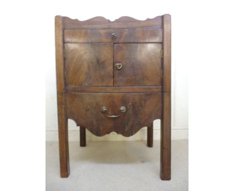 A George III mahogany night commode, having a pierced, galleried top, over a single drawer, a pair of doors and an additional