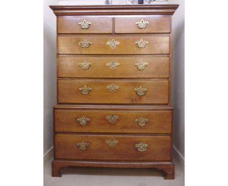 A George III mahogany chest-on-chest, having two short/five long graduated drawers with pierced brass bail handles on backpla
