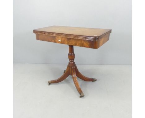 A Georgian style fold-over card table on turned column with sabre legs and brass casters. 85x76x43cm.Good condition. This is 