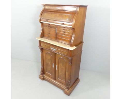 A Victorian burr walnut two-section dentist's cabinet, the top section having a cylinder top revealing a mirror above a marbl