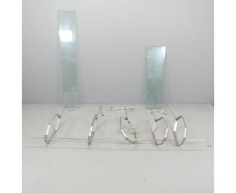 A modern chrome shop two tier hanging shelf system, with five brackets, two long (137.5x22.5cm) and four short glass shelves 