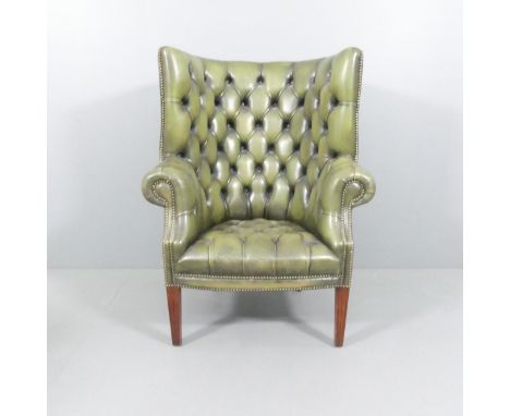 A button-back studded leather upholstered Chesterfield style arm chair. Overall 90x114x80cm, seat 46x42x52cm.Good used condit