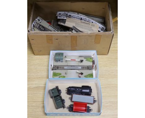 A German Marklin 7390 miniature rail station, tracking, engine and carriages, with original booklet