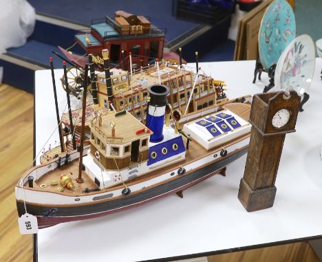 Two scratch built wooden model boats; a Mississippi style paddle steamer and a steam tug, together with a U.S. Western style 