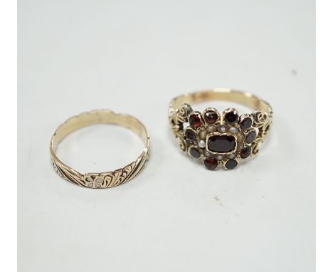 An early 19th century yellow metal, garnet and seed pearl cluster set ring, size P and a 19th century yellow metal and two co