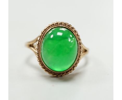 A 9ct gold and cabochon jade set oval ring (shank cut), gross weight 4.3 grams.
