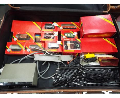 Model Railways - a suitcase containing a quantity of OO gauge track a Hornby Railways rolling stock predominantly contained i