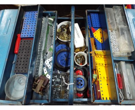 Meccano - a metal tool box containing a quantity of Meccano construction pieces to include plates, wheels, gear wheels, tools