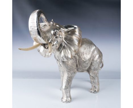 This remarkable Italian sterling silver elephant sculpture features a porcelain core and showcases intricate craftsmanship. T