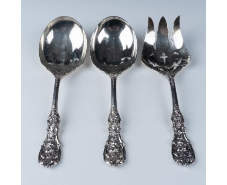 A stunning trio of sterling silver serving utensils, each featuring exquisite ornate floral and scroll motifs on the handles.