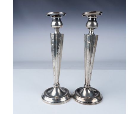 A pair of sterling silver candle holders with matching removable candle cups, each marked "Sterling" and "A.C." on the base. 