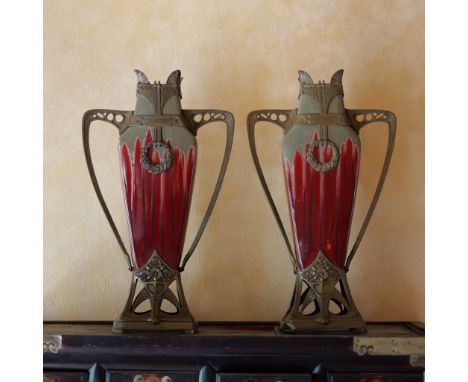 An exquisite pair of vases crafted from glazed ceramic and adorned with intricate bronze mounts. These vases feature an elega
