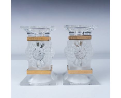 A pair of Lalique crystal Paquerettes candlestick holders featuring intricately detailed frosted floral motifs and accented w
