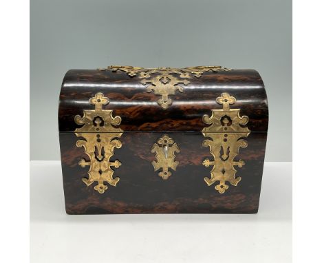 A fine Victorian rosewood tea caddy adorned with intricate brass mounts in Gothic revival style. The domed lid opens to revea
