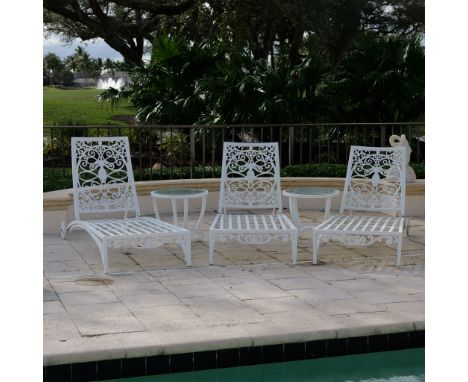 This 5-piece patio furniture set includes three white metal lounge chairs with ornate backrests and slatted seats, perfect fo