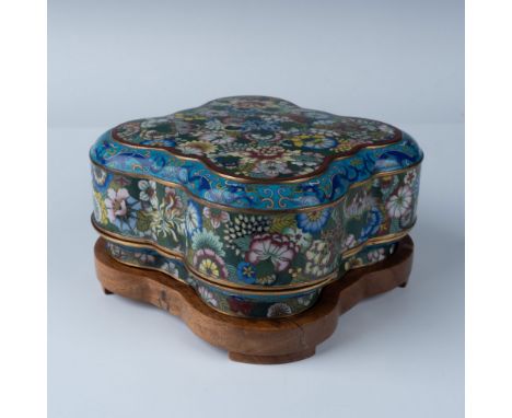 An exquisite Chinese cloisonne enamel lidded box featuring a vibrant floral motif in vivid colors, complemented by intricate 