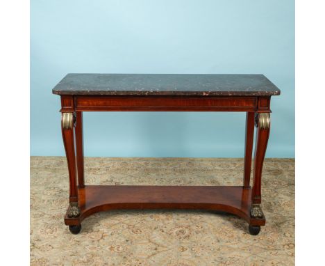 Elegant black marble top table with carved wood and scrolled front legs ending in claw foot. Ormolu leaf accents with open lo