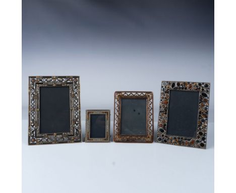 This lot features four ornate picture frames, each beautifully crafted with intricate metalwork and adorned with an array of 