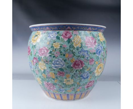 This stunning hand-painted Chinese porcelain fishbowl planter features an intricate floral motif with vibrant hues of pink, y