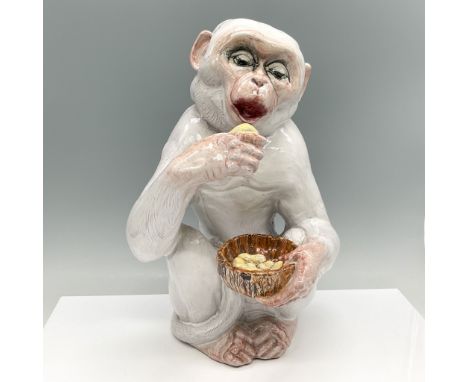 This charming Italian porcelain monkey figurine stands at 13.5"H, capturing a delightful scene of a monkey eating from a bowl