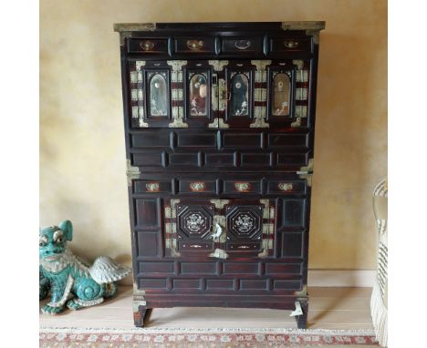 This exquisite lacquer cabinet showcases the elegance of traditional craftsmanship, featuring intricate mother-of-pearl inlay