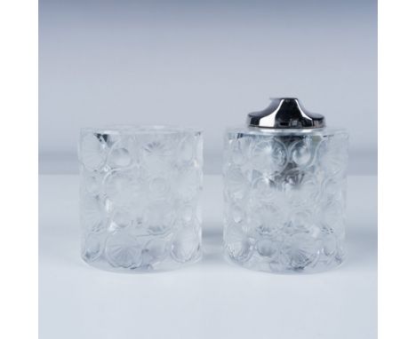 A striking pair of Lalique crystal table lighters, featuring a bold, impressed floral and dot design. Each marked Lalique Fra