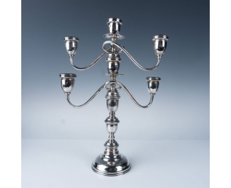 A classic sterling silver five-arm candelabra with an elegant and timeless design. This piece features intricate detailing an