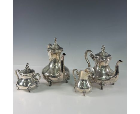 This exquisite set includes a coffee pot, tea pot, creamer, and sugar bowl with lid. All featuring ornate handles, finials, a