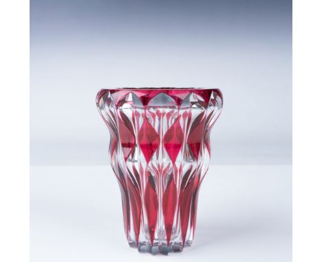 A stunning Val St. Lambert ruby cut-to-clear crystal vase, showcasing an intricate faceted design that enhances its vibrant r
