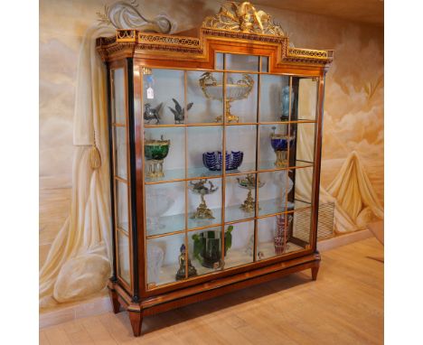 An exquisite antique Italian wooden  display cabinet made of cherry and yew wood. Decorated with finely hand crafted gilded w