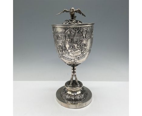Finely crafted Chinese Export Silver goblet with lid, featuring intricate repoussé and engraved designs depicting traditional